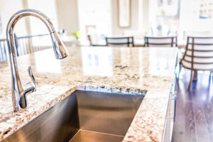 stainless steel sink in a granite kitchen